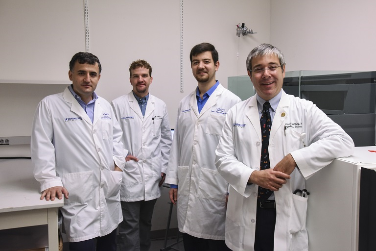 Four doctors wearing lab coats.