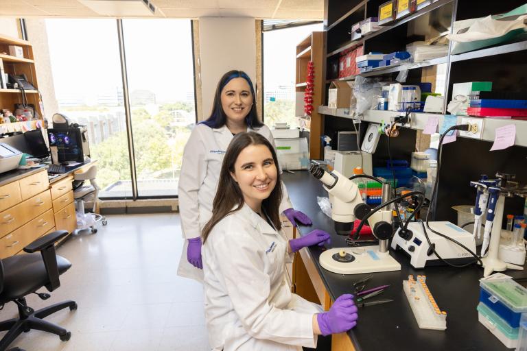 Emily and Dr. Wert at the microscope