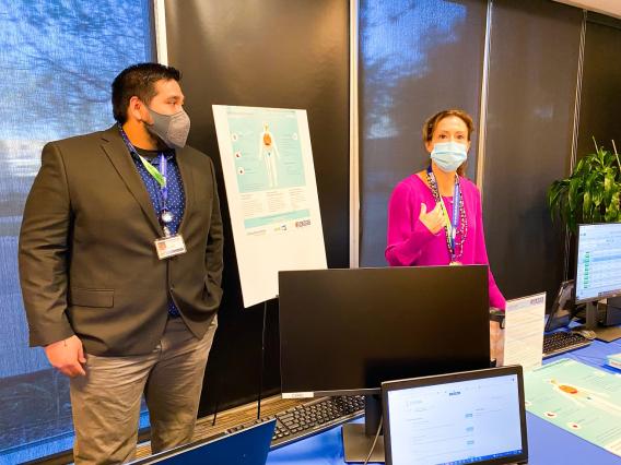 Two lab members at CDRC Spring event in Fort Worth showcasing VitalSign6 and Evexia.