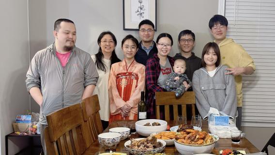 MUDIA lab team and families at a group dinner.
