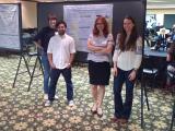 Kathryn's poster at Mol Micro Retreat and other three people