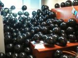 Office filled with black balloons