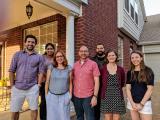 Conrad Lab Members gather on front porch of house