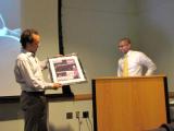 Raghu Chivukula Thesis Defense - Dr. Mendell presenting framed gift