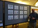 Team member displaying posters