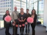 Five team members at Olga's Baby Shower, holding letter "J" and banner "Julia"