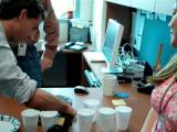 Stefan pouring champaign as team members watch