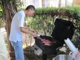 Team member grilling food at pool party