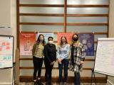 masked women in front of posters