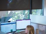 person at desk near window