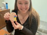 Jane holding a kidney shaped sugar cookie