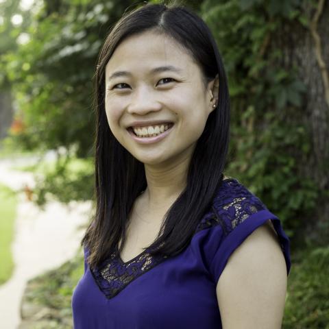 Smiling woman with long dark hair.